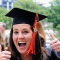 renovating-your-mind-looks-at-college-graduation-college-costs-jobs-female-graduate-gives-thumbs-up