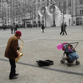 saxophone-player-on-street-only-watcher-is-a-baby