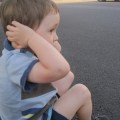 child-covering-his-ears-to-protect-from-useless-government-noise