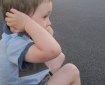 child-covering-his-ears-to-protect-from-useless-government-noise