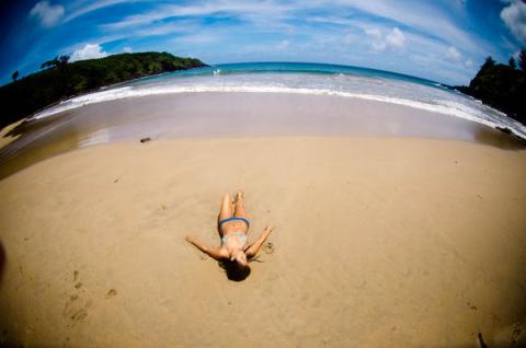 girl-getting-tan-by-herself-on-beach