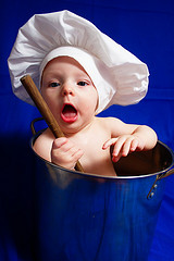 chef-baby-learning-early-to-cook-from-inside-big-stock-pot-